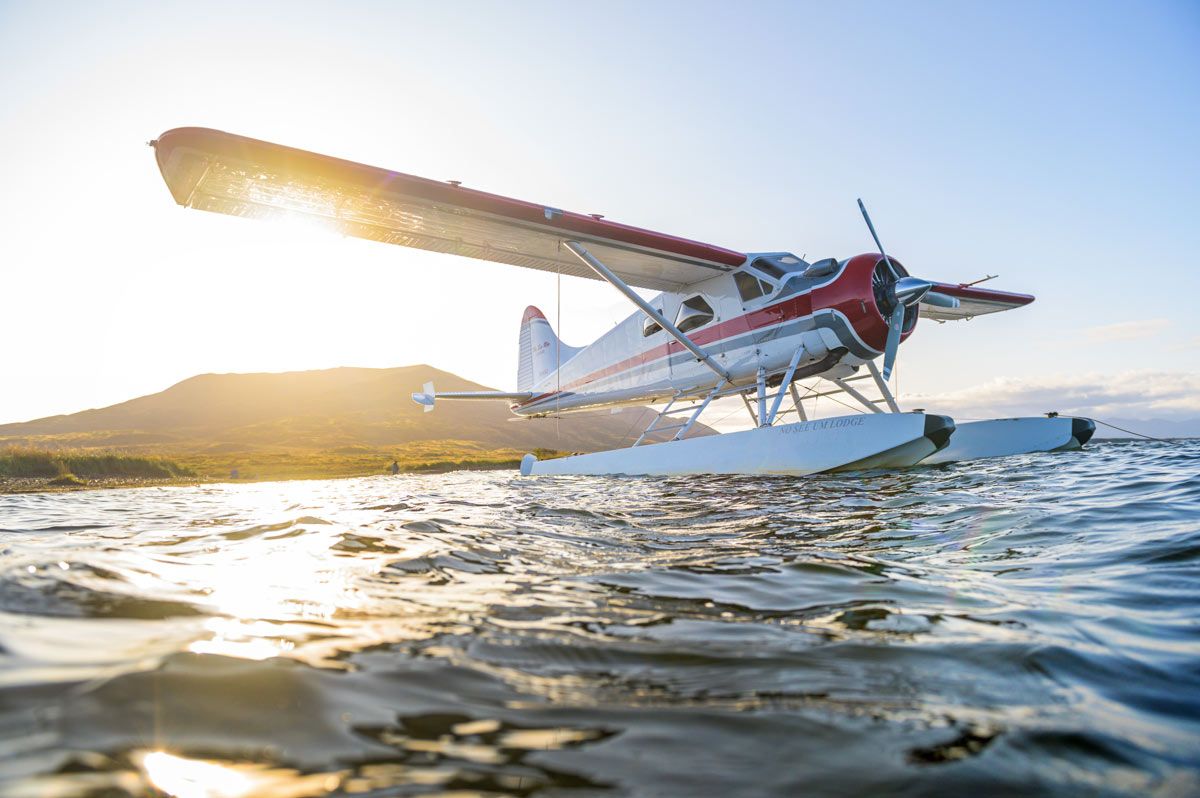 DeHavilland Beaver on floats with glowing sun